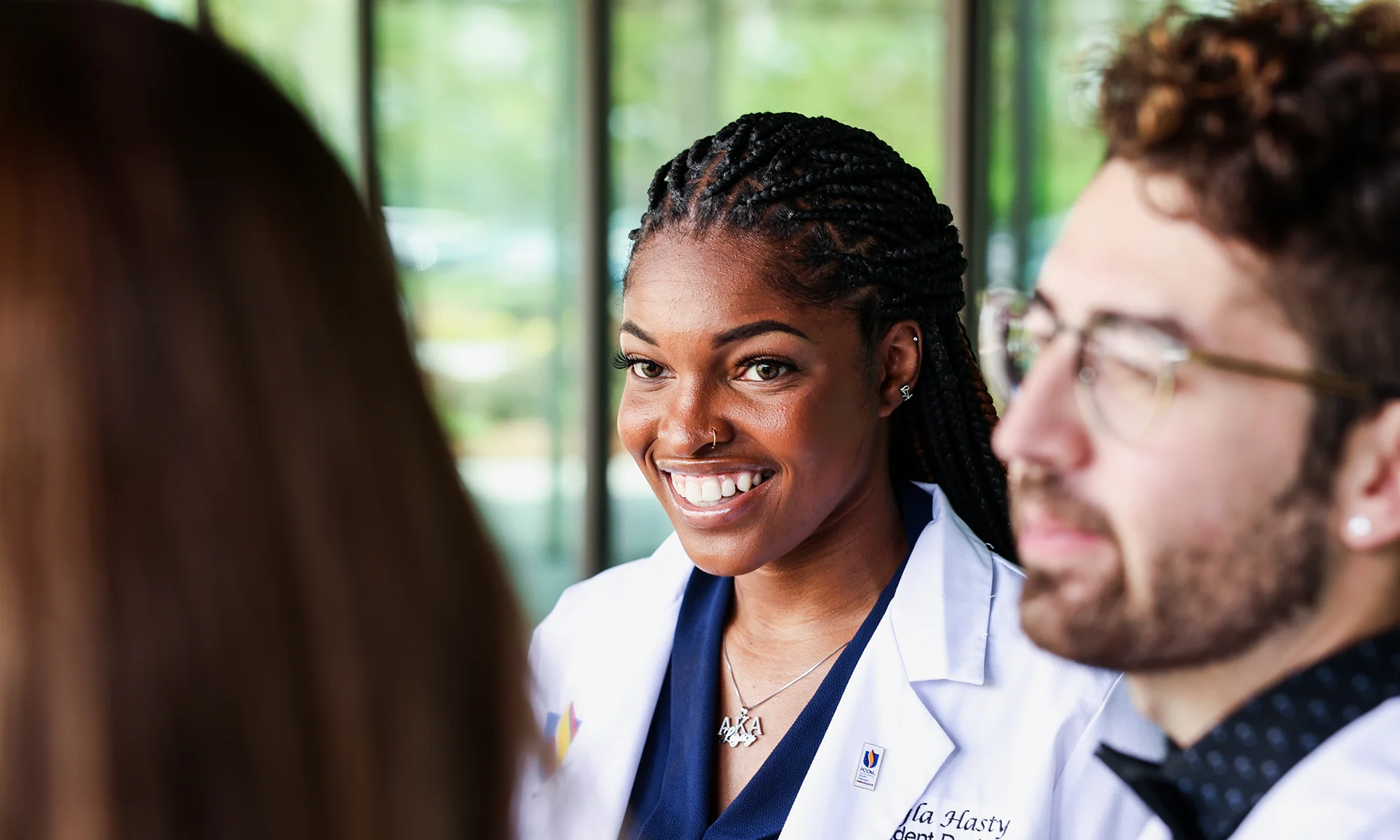 PCOM medical students smiling and talking with prospective students about admissions topics