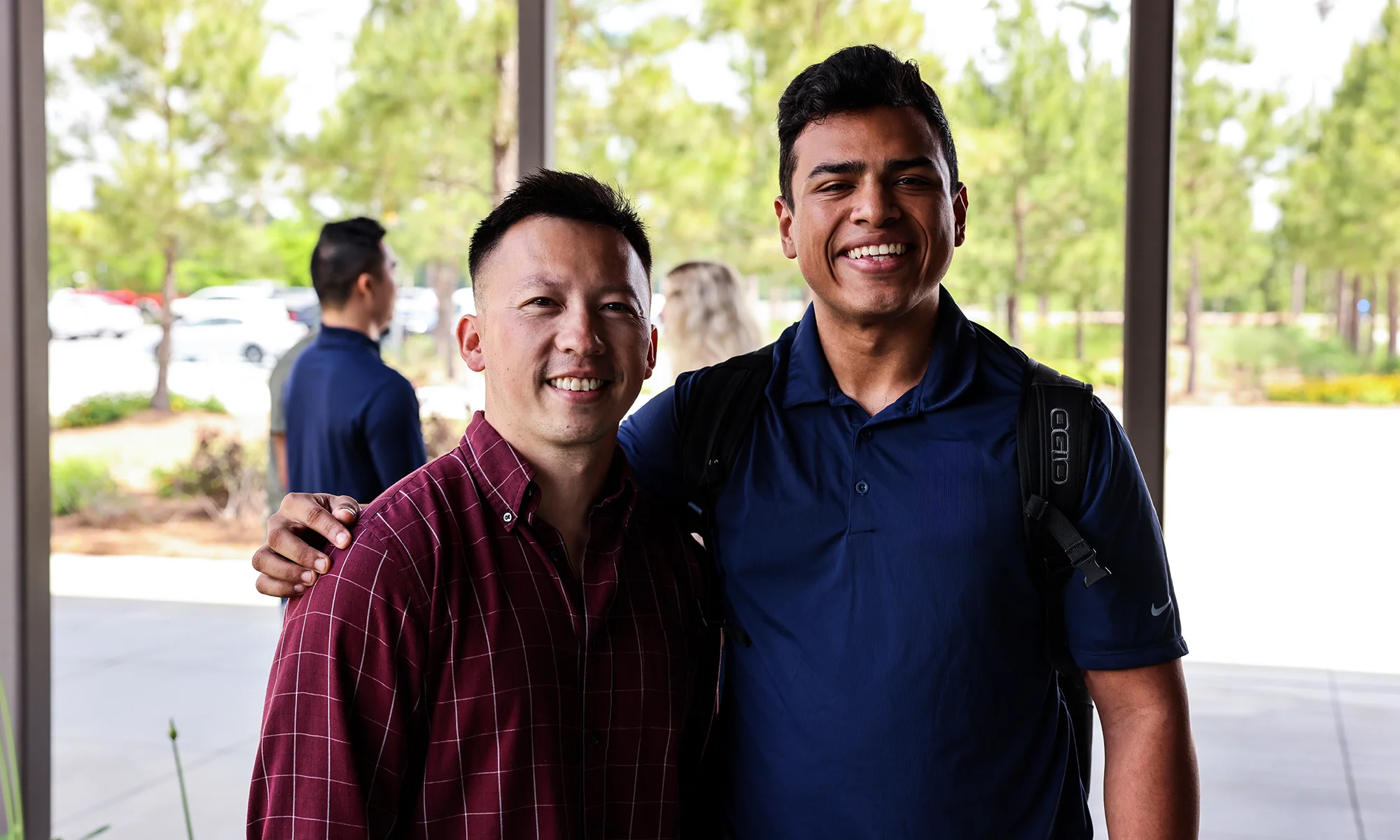 Two graduate students smiling in the courtyard at PCOM South Georgia in Moultrie, GA