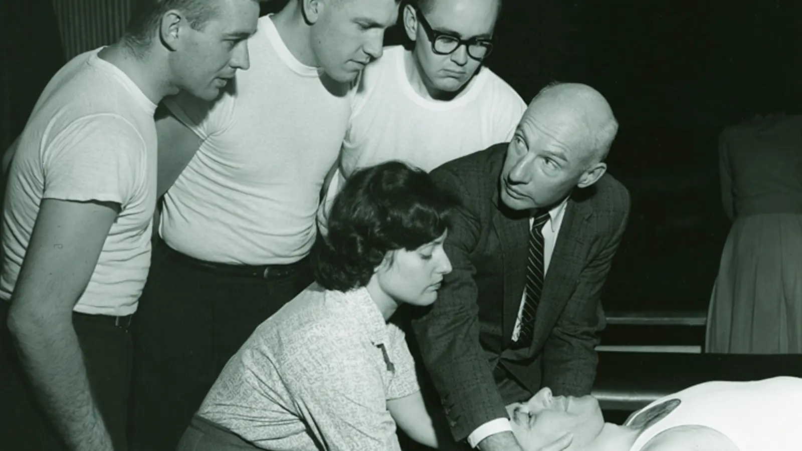 PCOM medical students learn from a faculty member during an OMM classroom session in the 1960s