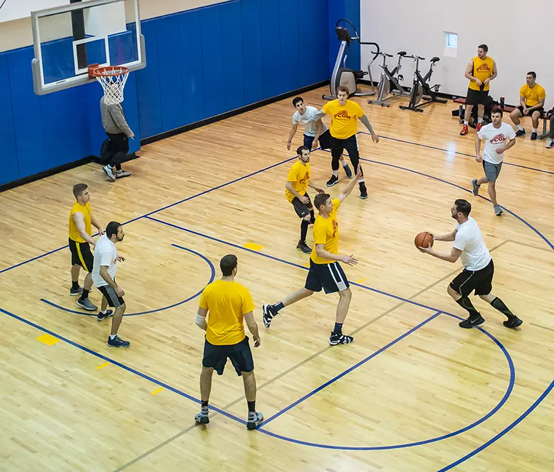 Top down shot of PCOM students playing an intramural basketball game in the Philadelphia campus' Activities Center.