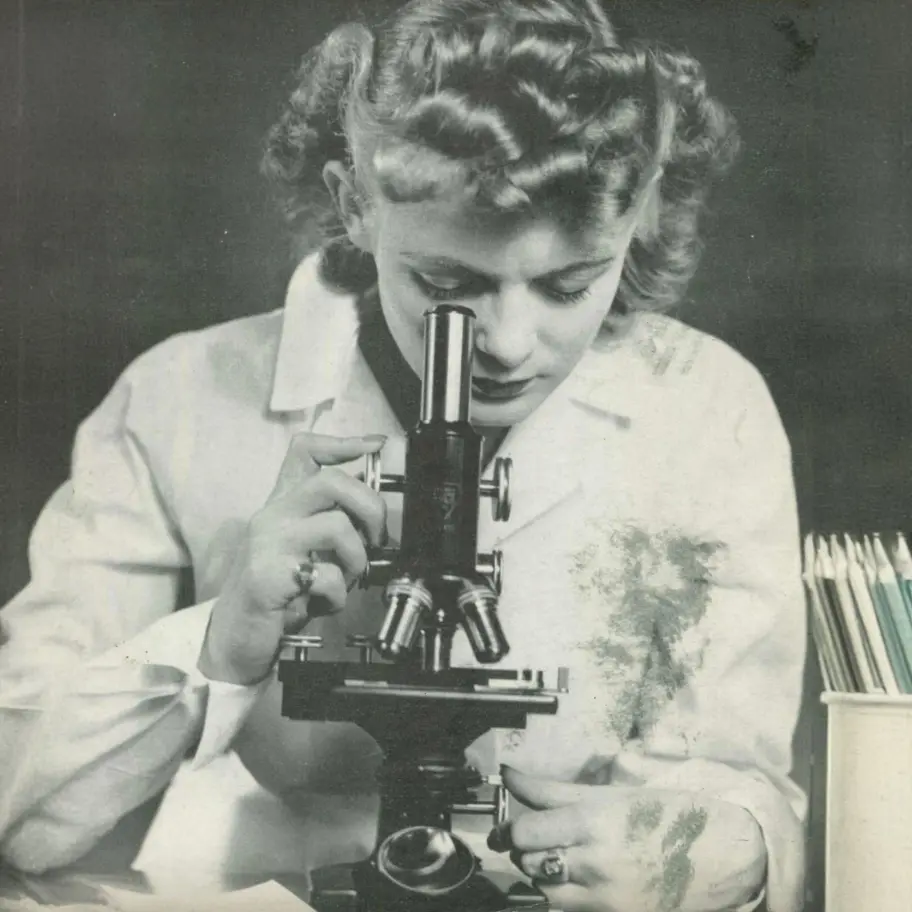 Vintage photo from 1949 of a female PCOM medical student using a microscope in a research laboratory