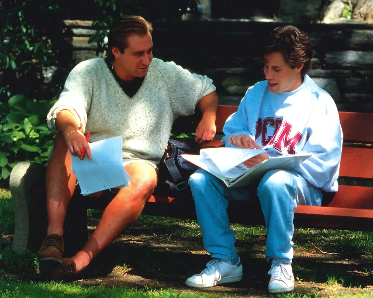 PCOM students converse on park bench, circa 1995