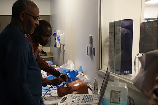 Dr. Frank Jones works with an internal medicine resident to place a central line with ultrasound guidance.