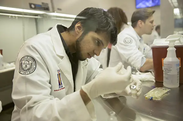 A pharmacy school student works in the sterile products lab.