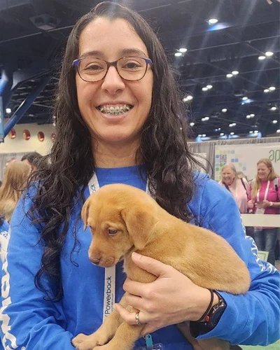 DPT student Gabriela Ba holds a puppy at the American Physical Therapy Association meeting