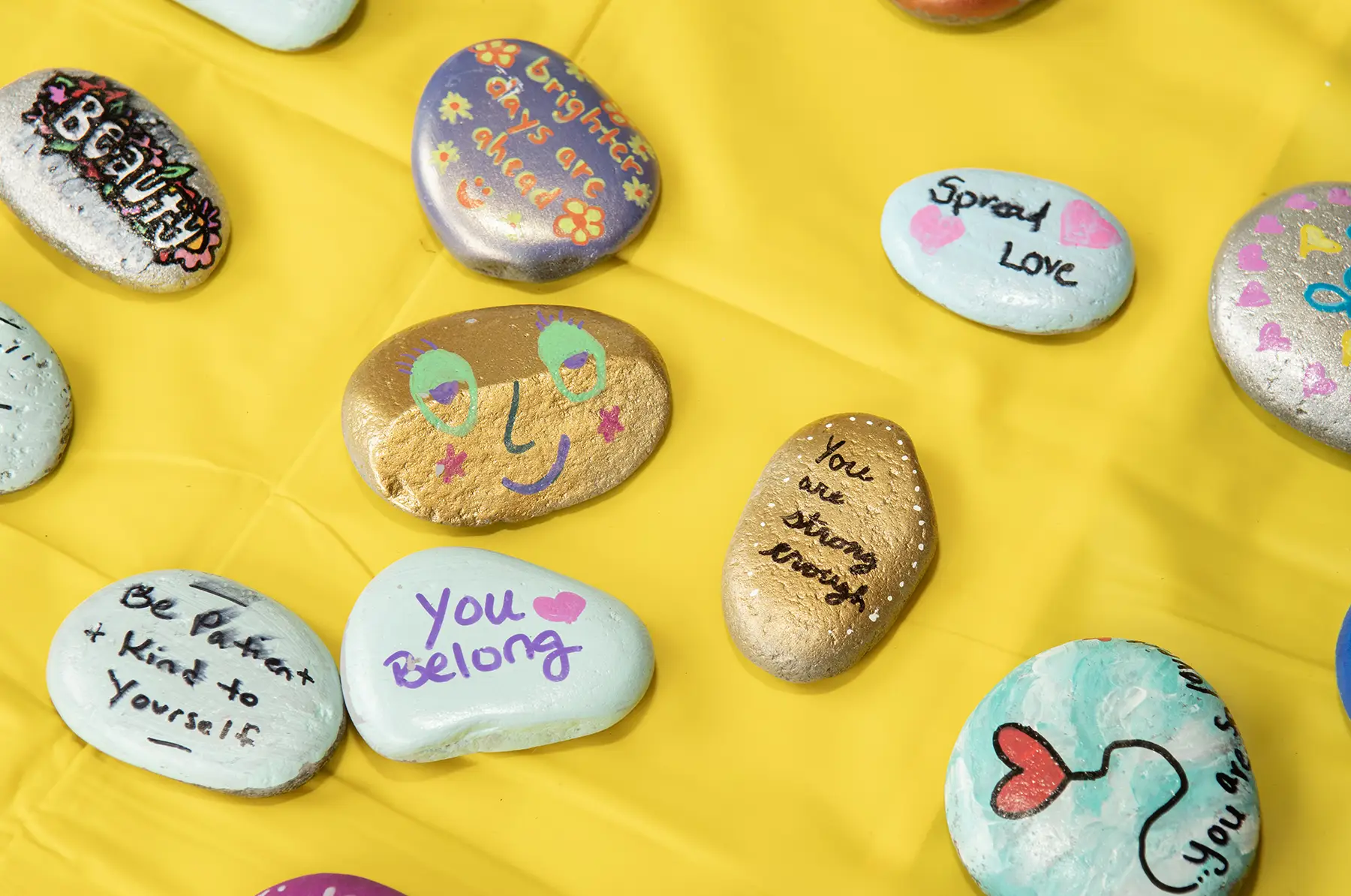 Rocks painted with messages of positivity and kindness.
