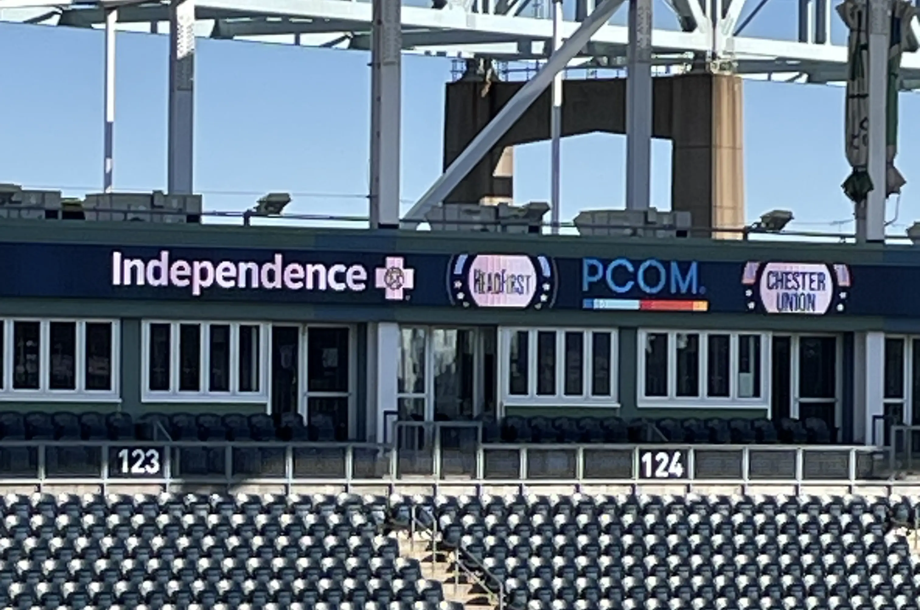 PCOM sign in a stadium.