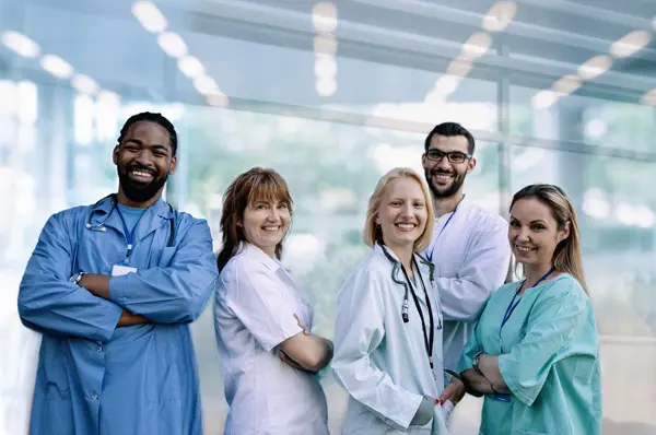 Emergency medicine physicians smile in a group shot in a medical center