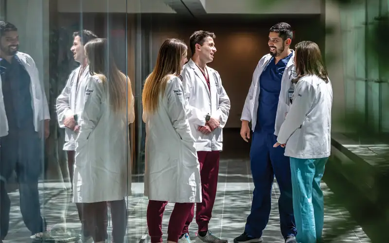 Prior to morning rounds, third-year clerkship students meet residents in the grand atrium of the Annenberg Center for Medical Education, Lankenau Medical Center.