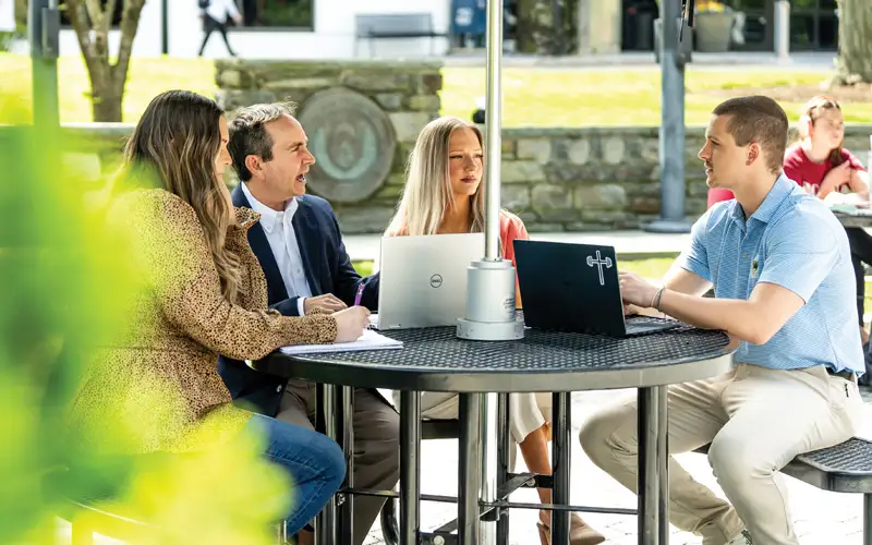 Scott Glassman, PsyD ‘13, clinical associate professor and director of the Master of Applied Positive Psychology program, and students sit outside of Hassman Academic Center, PCOM, to share insights and experiences. These future psychologists find balance and inspiration in each other’s company.