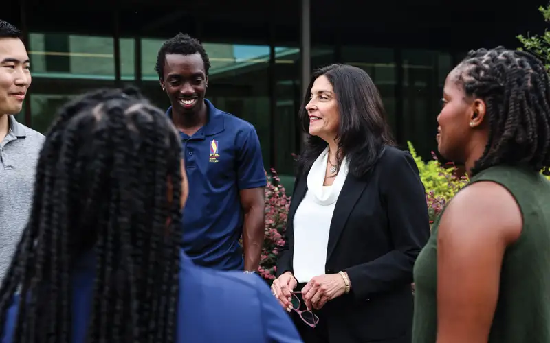 During a break between classes, students from PCOM South Georgia enjoy a moment of camaraderie and mentorship in Jeter Courtyard with Marla D. Golden, DO ’88, MS, FACEP, dean of the osteopathic medical program.