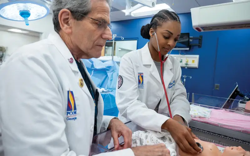 In PCOM Georgia’s Simulation Center, Gary Freed, DO, FAAP, FACOP, professor of pediatrics and director of primary care skills, uses a newborn high-fidelity manikin to demonstrate pediatric procedures and diagnosis.