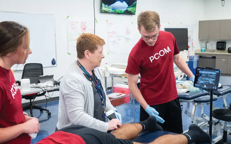 Ruth M. Maher, PT, PhD, DPT, WCS, professor and department chair, physical therapy, PCOM Georgia, instructs physical therapy students in the use of ultrasound imaging as they learn to visualize internal structures and precisely guide therapeutic interventions.