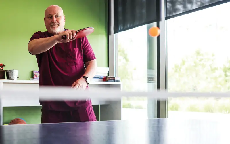 Randall L. Sisam, DO, MBA, assistant professor of clinical medicine and director of primary care skills, serves up a friendly match of ping-pong during lunchtime, rallying with PCOM South Georgia students in a spirited exchange of volleys.