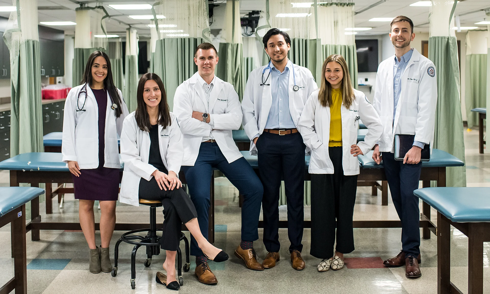 Physician assistant students smile in the PA Studies learning suite at PCOM