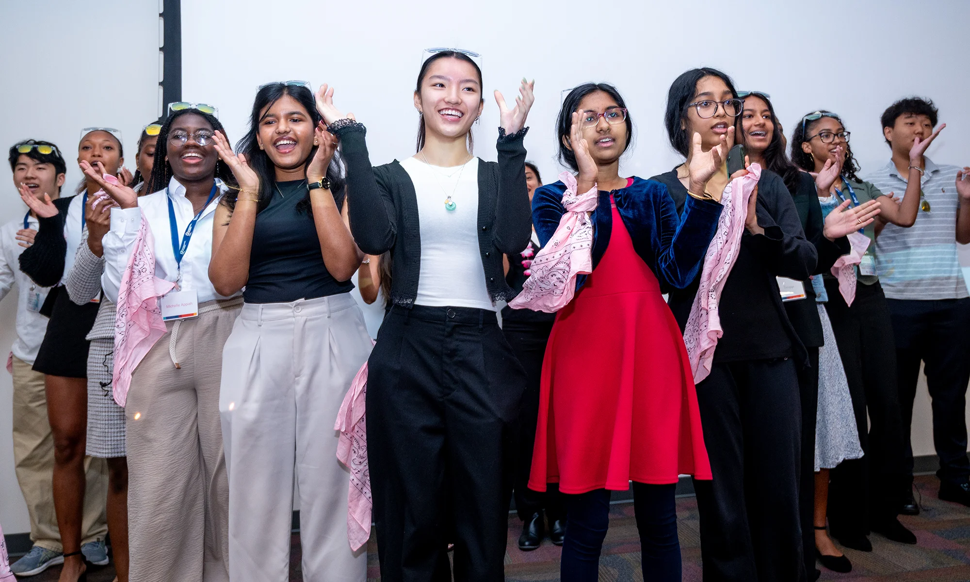 Opportunities Academy participants smiling and cheering during a presentation ceremony