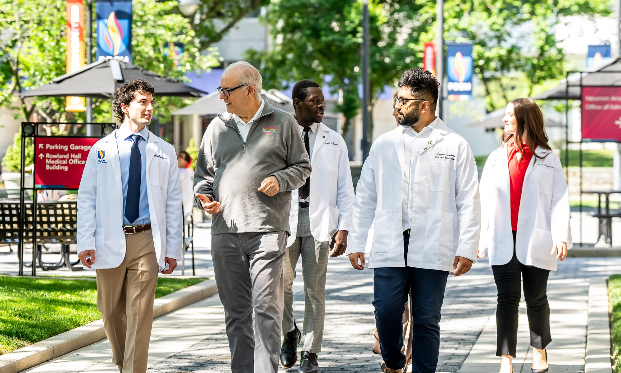 PCOM students walking and talking with faculty outside on the Philadelphia campus