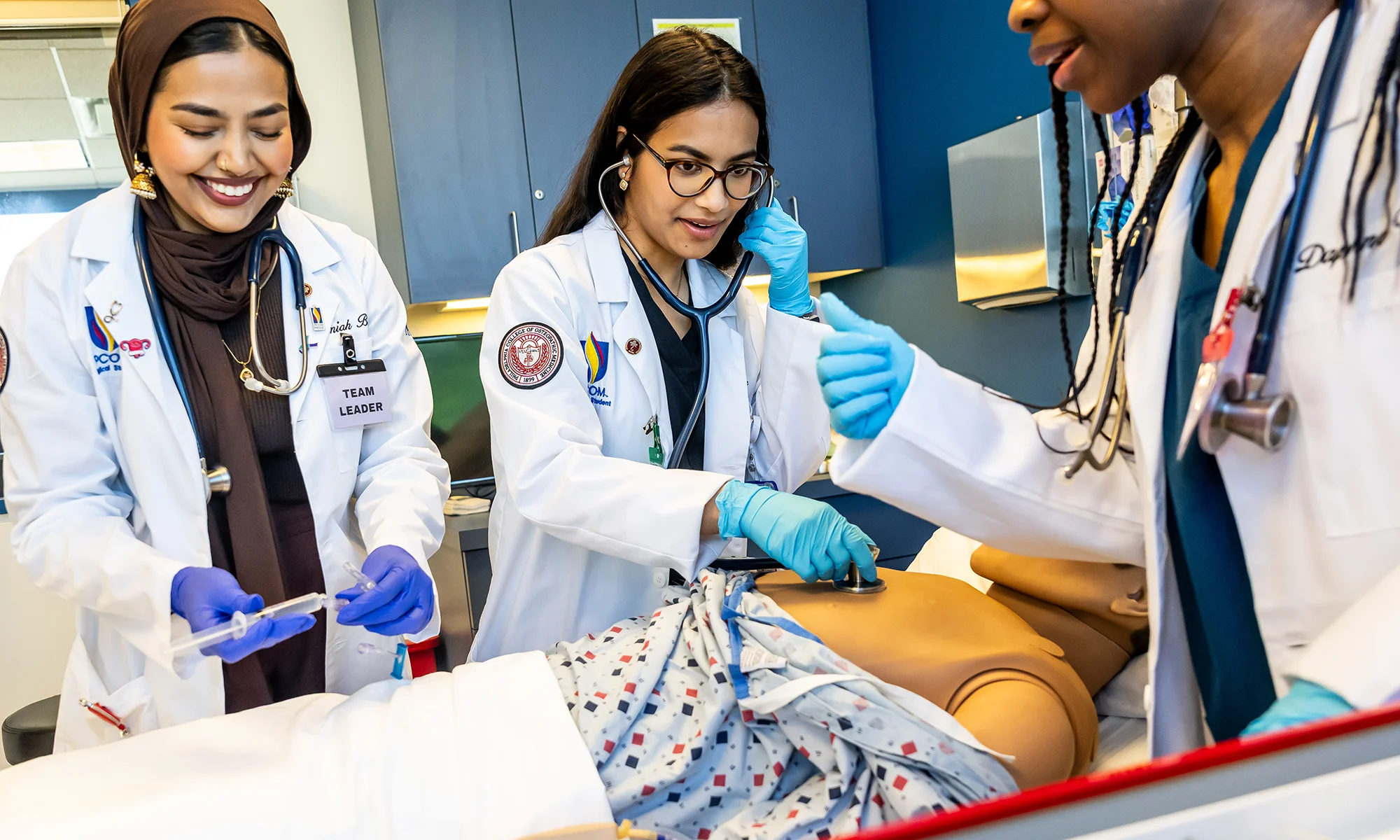 PCOM medical students conducting a simulated trauma exercise on a high fidelity mannequin in the Saltzburg Simulation Center at PCOM