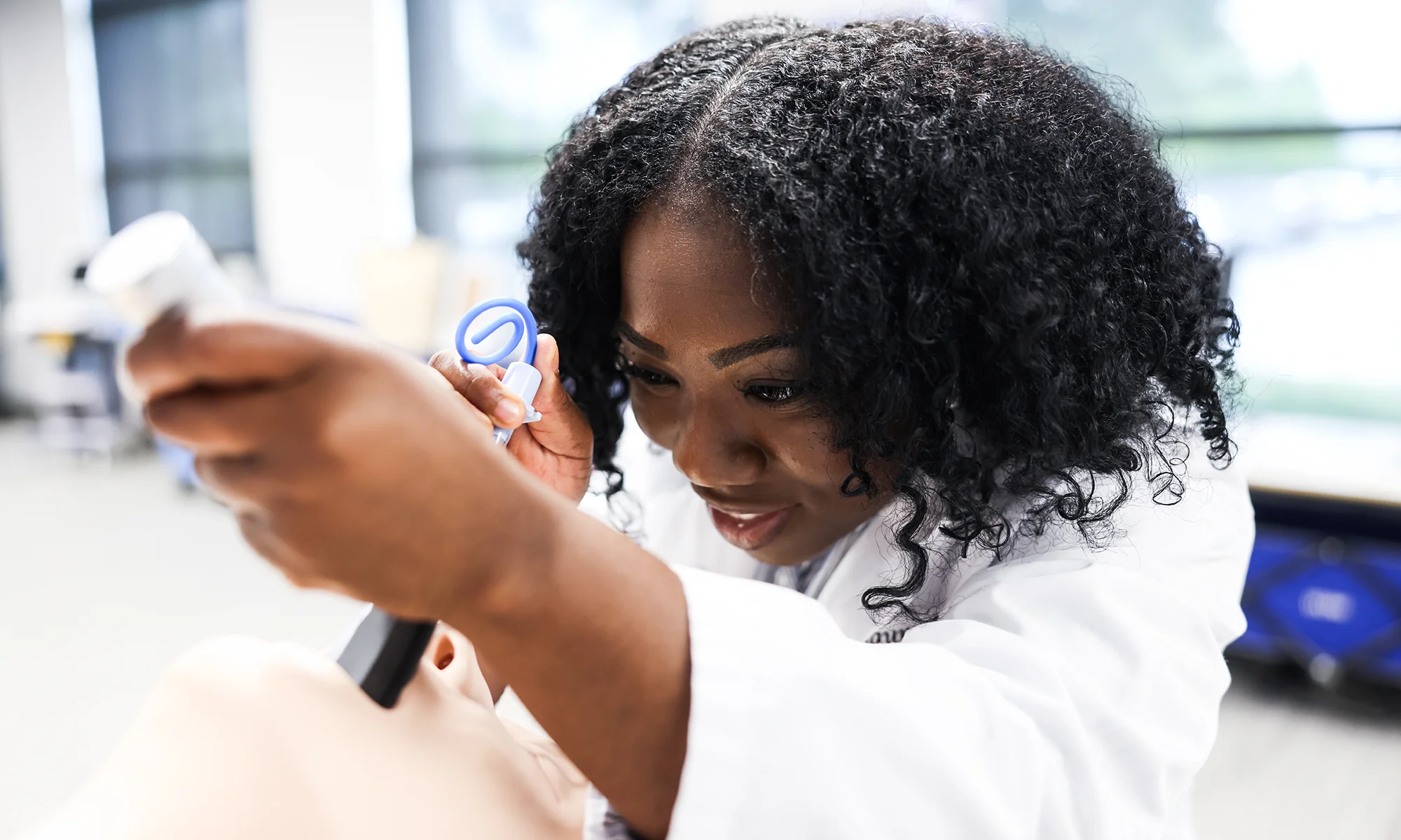 PCOM South Georgia medical student practicing with instruments in the Simulation Center