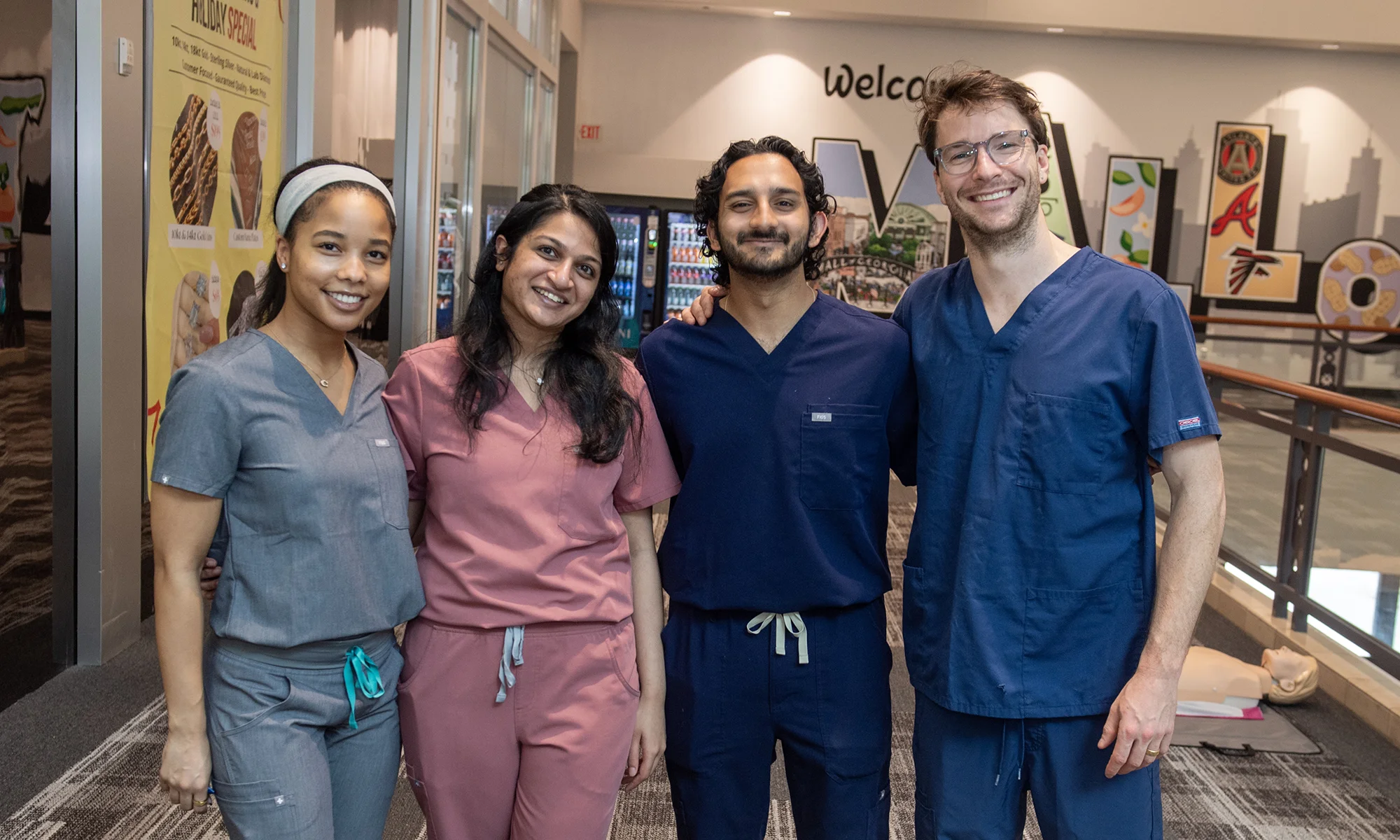 PCOM Georgia medical students smiling during a CWI CPR demonstration event at the Mall of Georgia