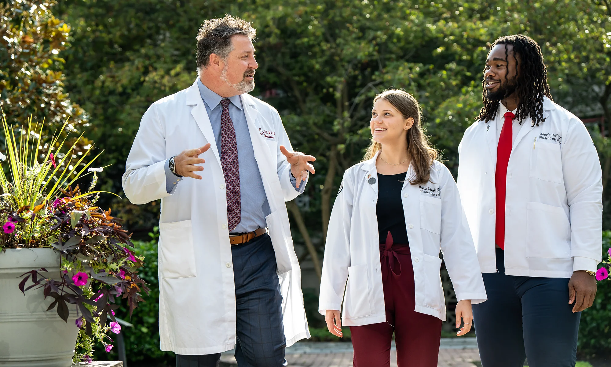 PCOM doctor of osteopathic medicine students and faculty walking and talking outside
