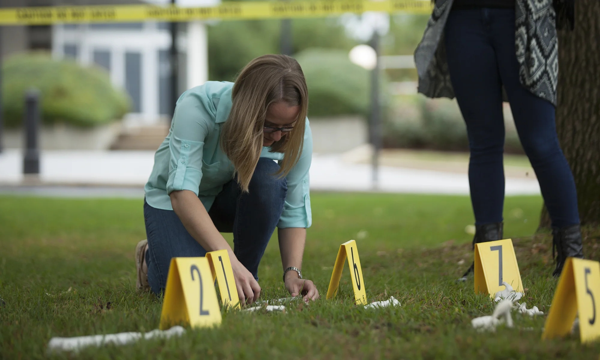 A PCOM forensic medicine student working with a hands-on investigation learning exercise outdoors