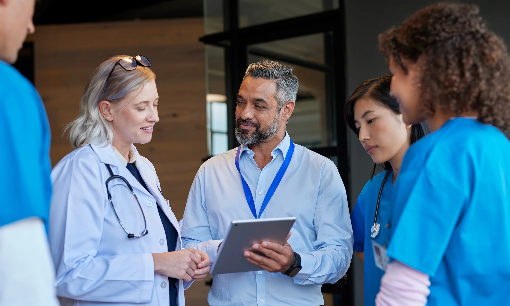 Medical professionals and physicians smiling while discussing new medical technology
