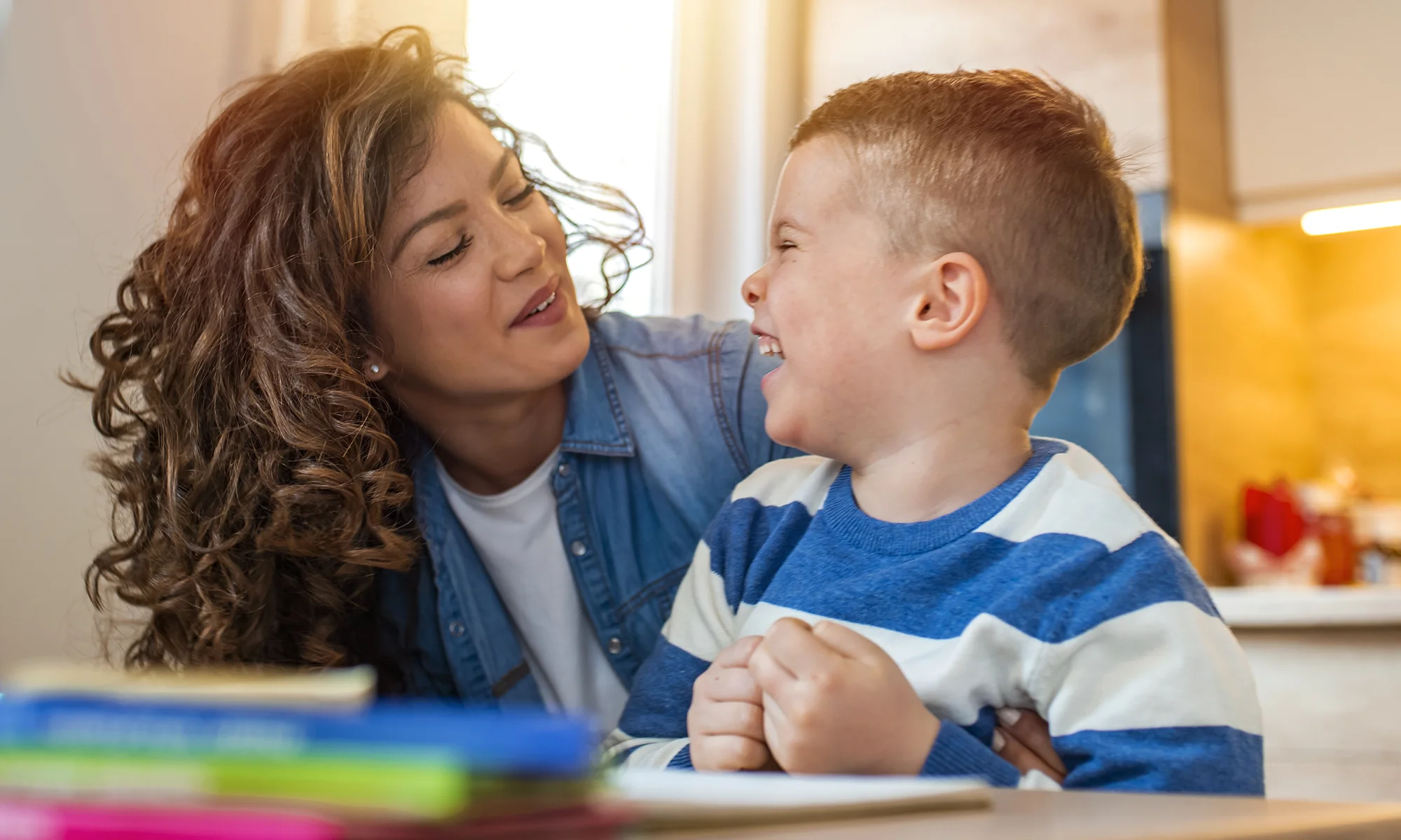 PCOM educational specialist student laughing with a child during a school psychology session