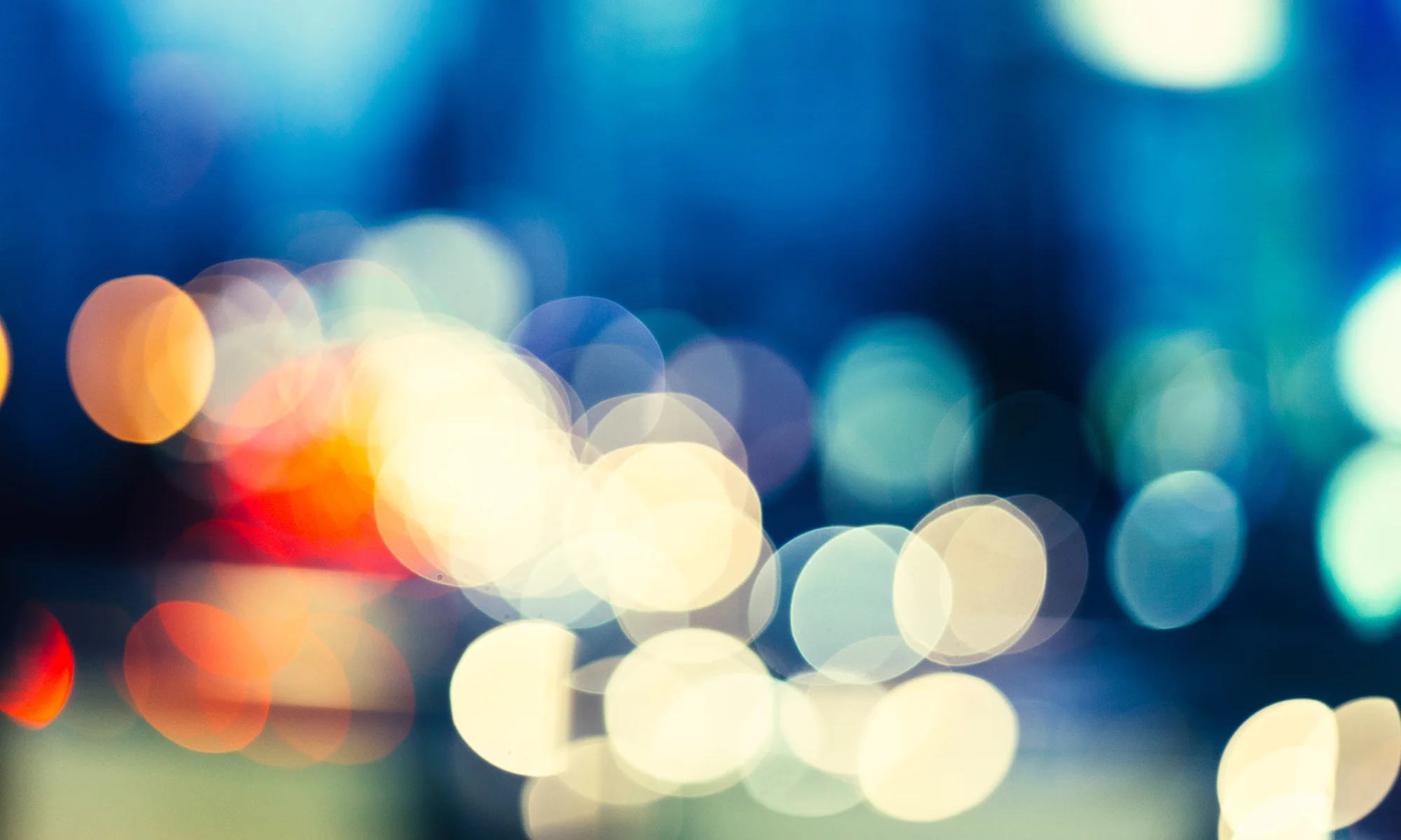 Macro shot of police lights and city lights representing gun violence research