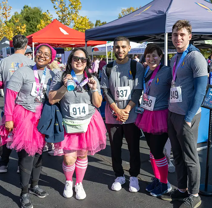 PCOM Georgia students and Dr. Andrea Mann in athletic gear during the Paint Gwinnett Pink 5K event