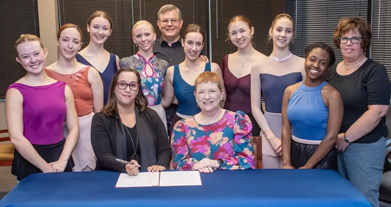 Members of the Gwinnett Ballet Theatre pose with Dr. Ruth Maher