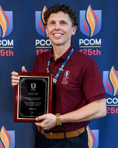 Brent Cox poses with DEI Award