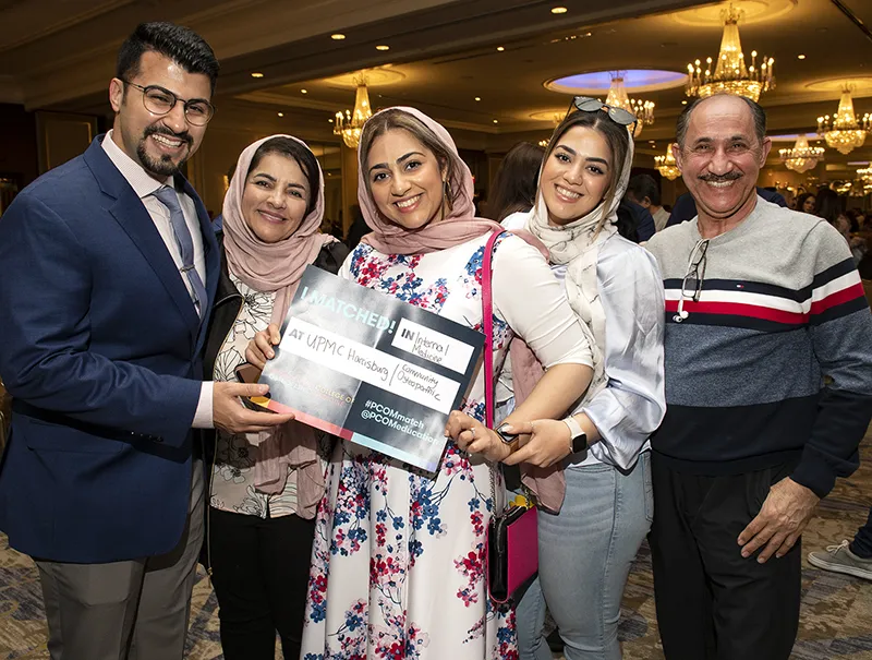 A PCOM osteopathic medical student and her family smile during a Match Day celebration event