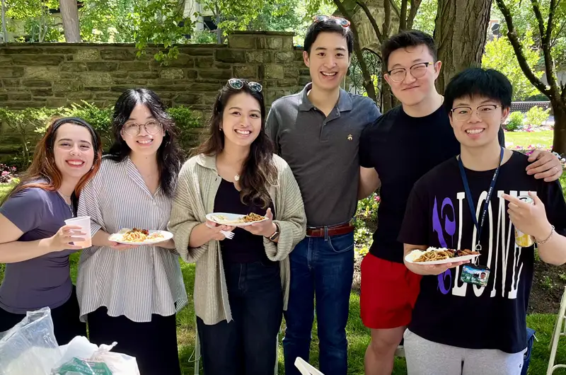 Tyler Kung (DO ’27) smiling with a group of students in the PCOM chapter of APAMSA