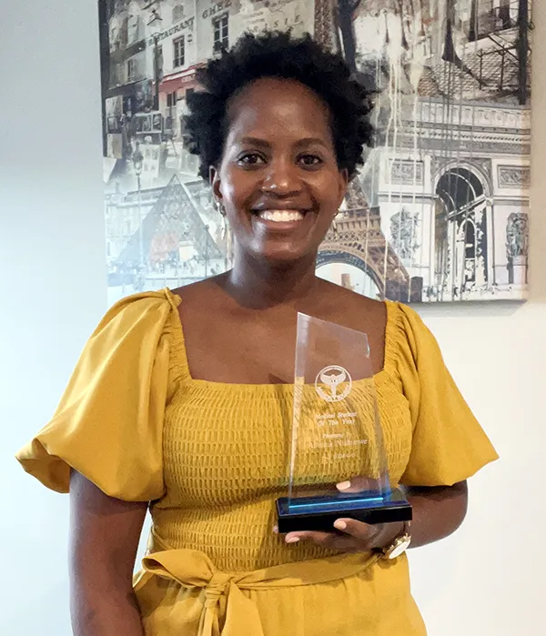 Photo of PCOM South Georgia med student Alleluia Nishimwe (DO '26) holding her award