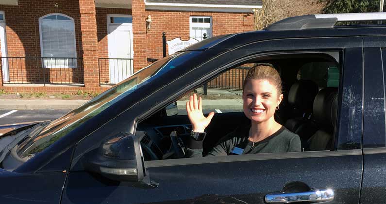 Assistant Director of Admissions Dana Brooks waves from her car.