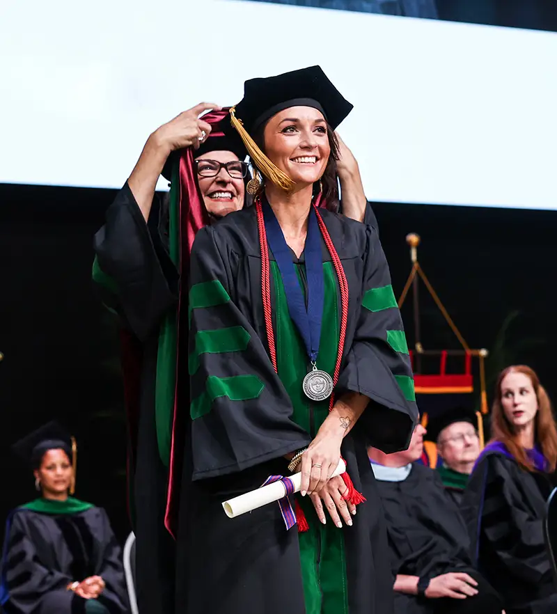 Katie Bombly, DO '24, during the hooding ceremony
