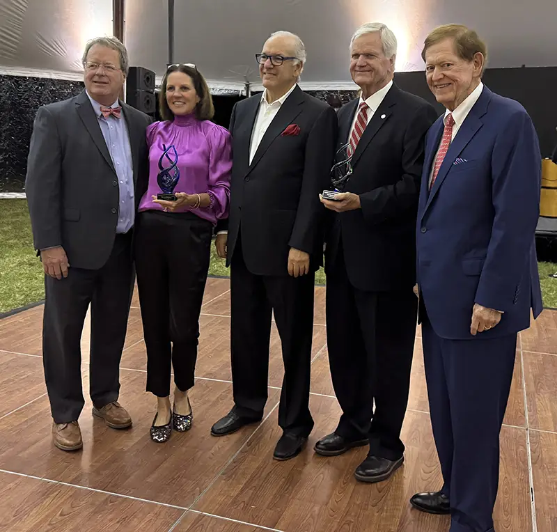 PCOM President Jay S. Feldstein smiles with Ignite award winners im and Jill Matney as well as Dan Jeter and Jimmy Jeter