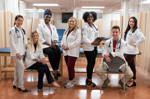 Group of PA Studies at PCOM Georgia posing in exam room