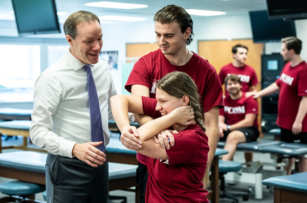 PCOM medical students learn OMM technique from faculty member