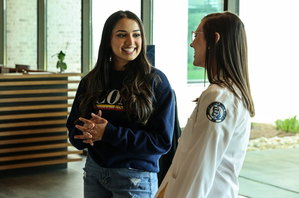 Two young students converse in the PCOM South Georgia lobby