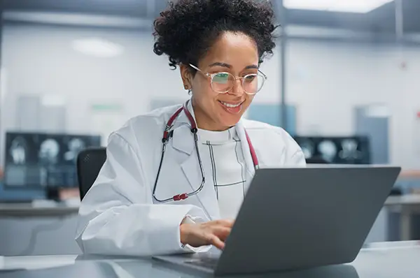 PharmD student working on laptop computer in lab