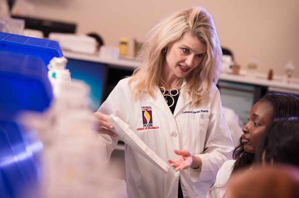 Pharmacist reviews medication with colleagues