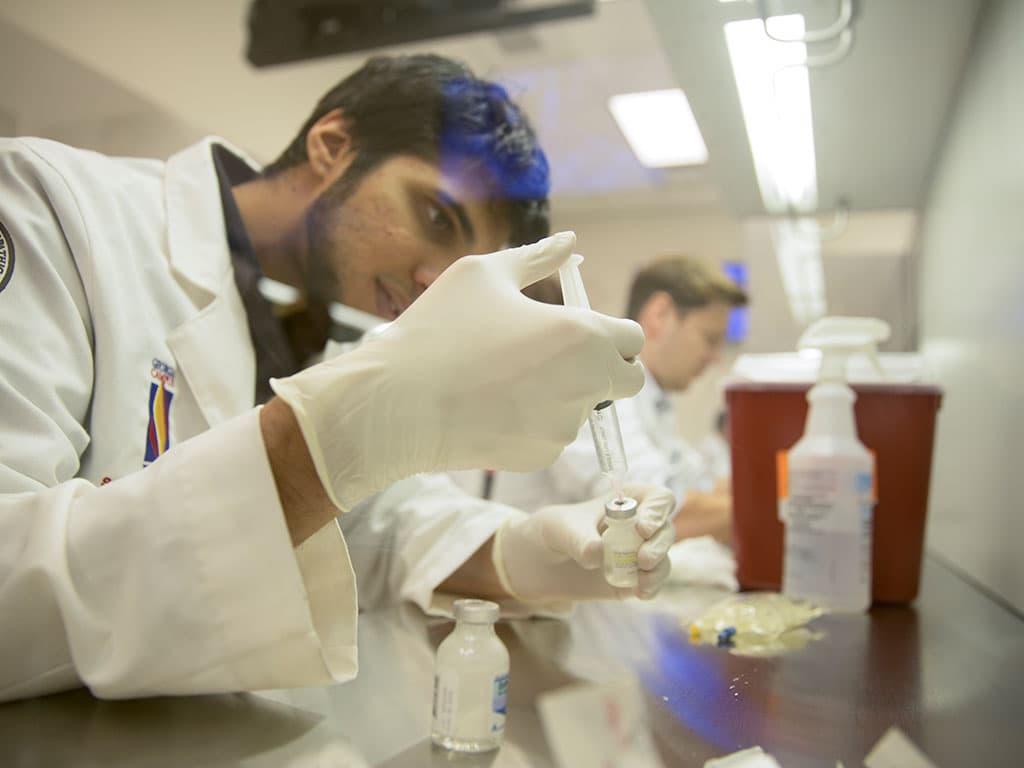 Pharmacist fills syringe