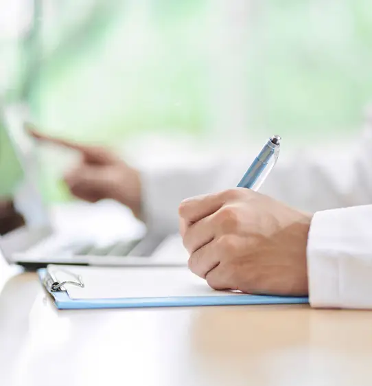 A researcher writes a note.