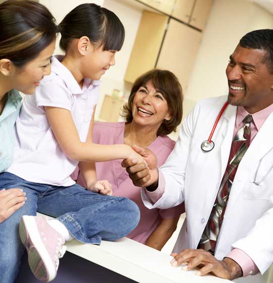 Family Medicine doctor and staff interacting with child and parent