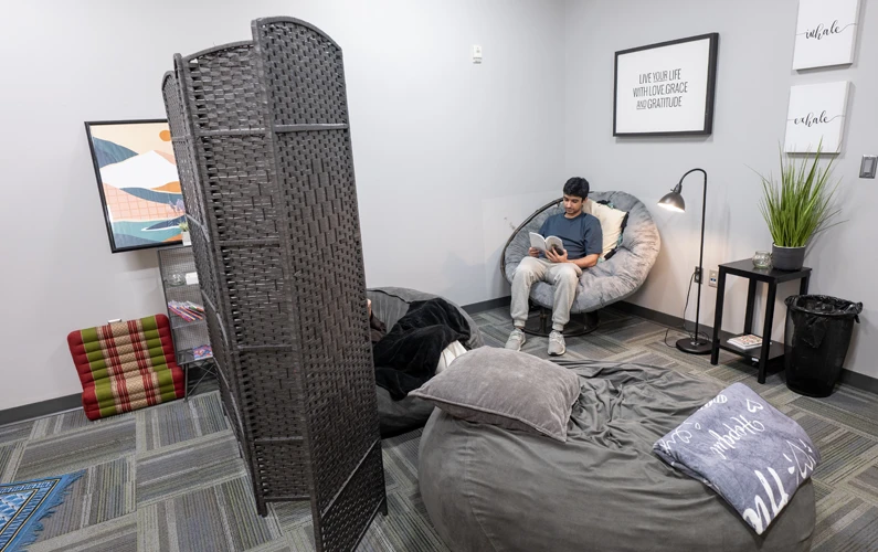 Beanbag chairs, large comfy chairs, blankets and wall hangings within PCOM Georgia's Meditation Room